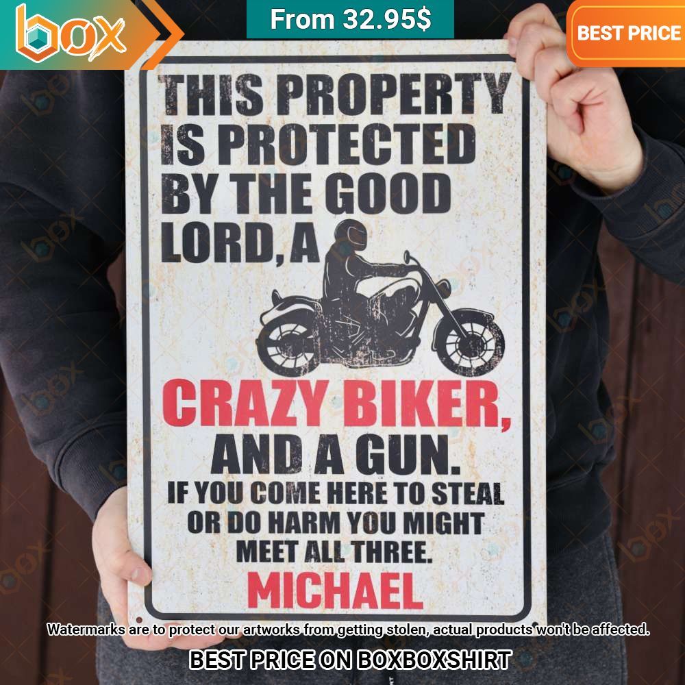 this property is protected by the good lord a crazy biker and a gun metal sign 1 668.jpg